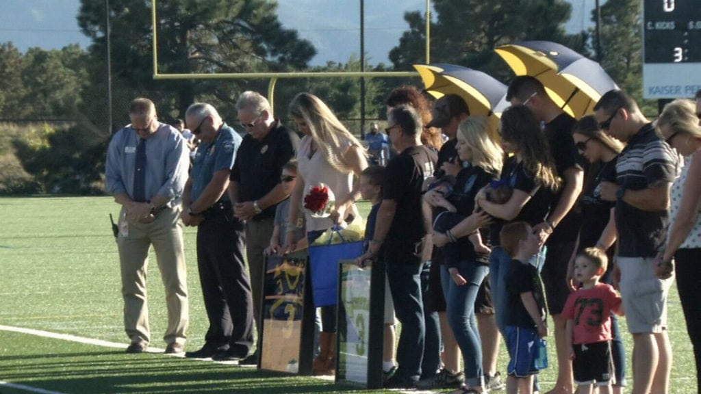 The CSCS Lions football team honor fallen El Paso County Sheriff's Deputy Micah Flick before their game Sept. 13, 2018. Flick went to high school at CSCS and played quarterback for the Lions. The team retired his No. 3 jersey.