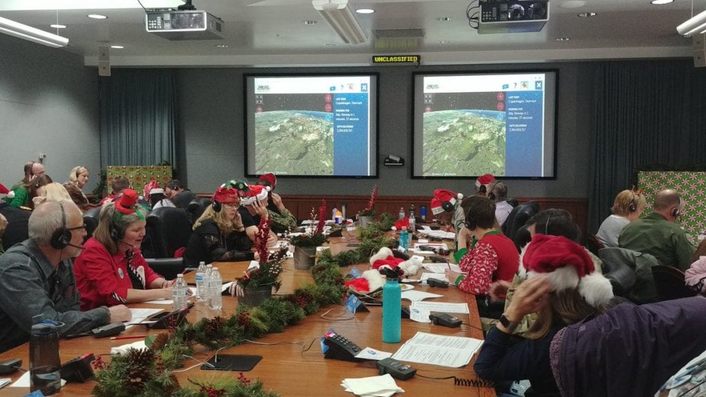 Volunteers answer the phones as part of the annual NORAD Santa Tracker event. More than 1,600 people answers calls on Christmas Eve asking where Santa is.