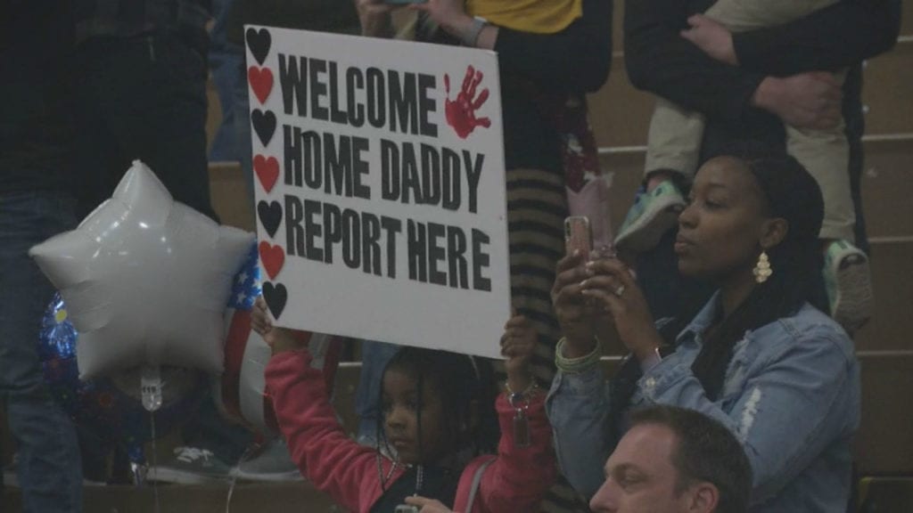 A mother and her daughter cheer as some 50 soldiers return to Fort Carson from a nine-month deployment in Afghanistan.