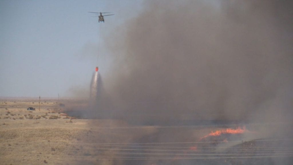 A helicopter drops water on the Carson Midway Fire on March 16, 2018.